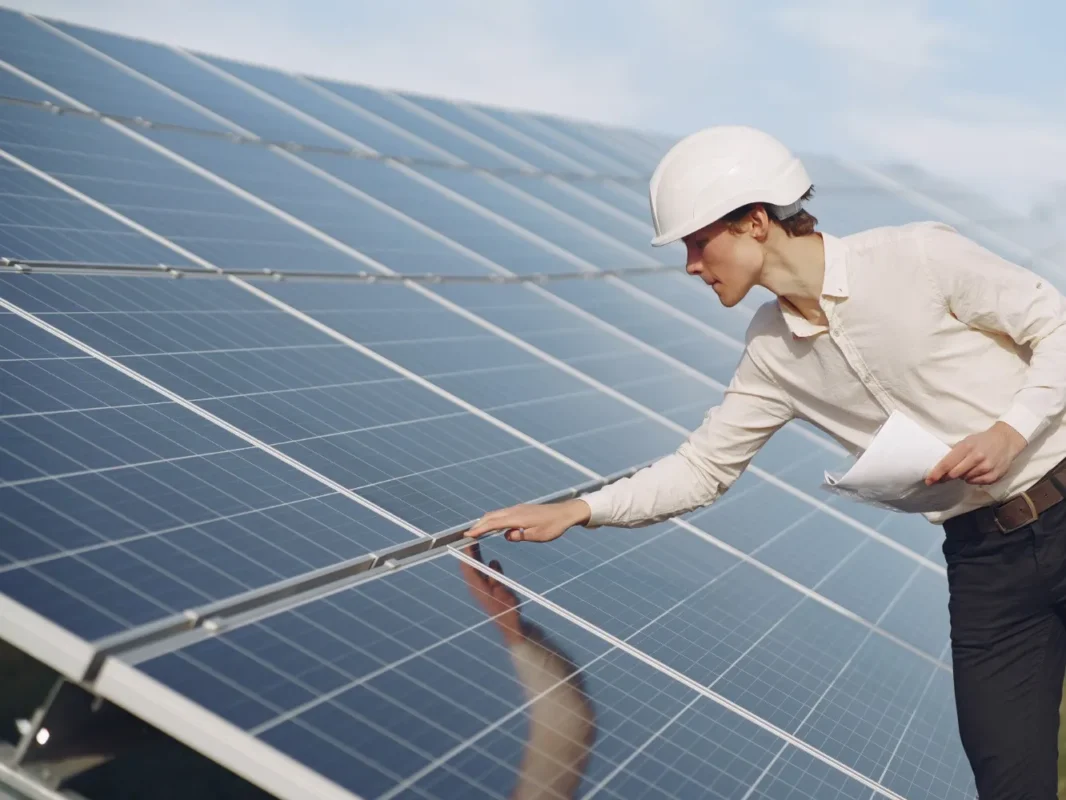 Solar technician inspecting panels